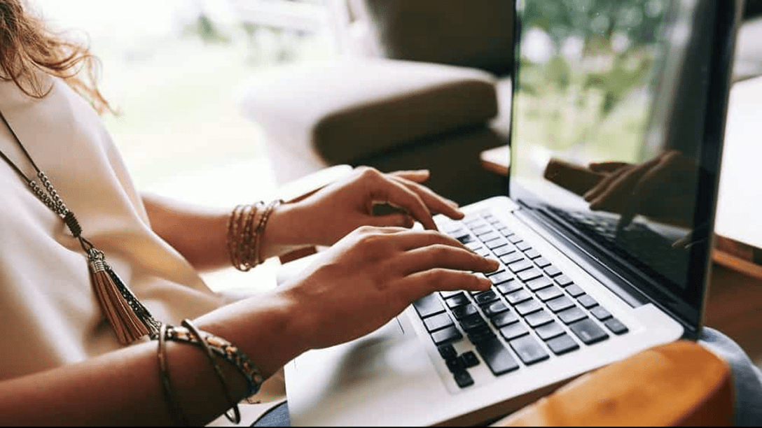 Lady typing on laptop.