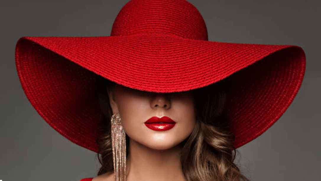 Banner lady wearing very large red fashion hat.